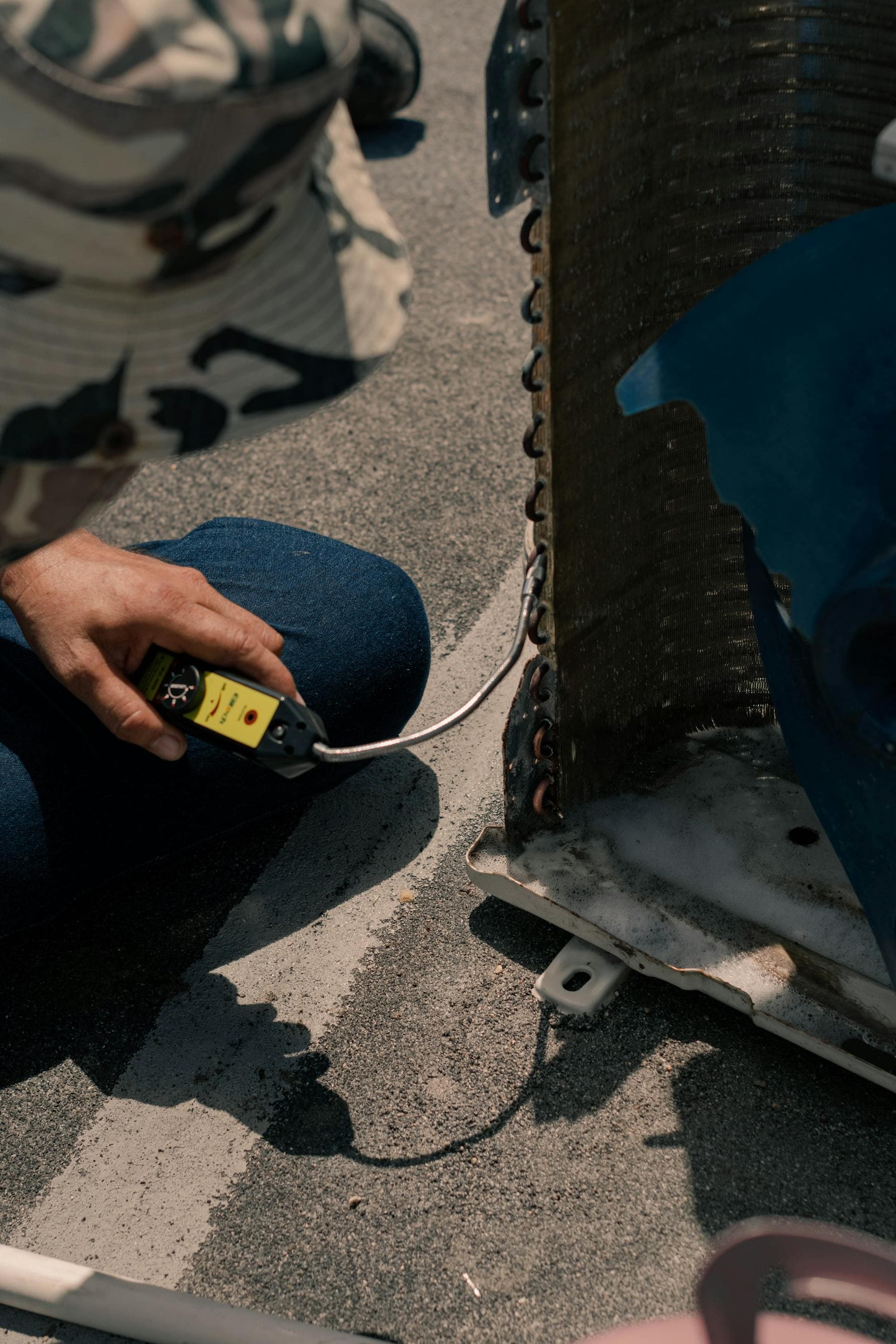Close-up of air conditioning diagnostic work on an outdoor unit
