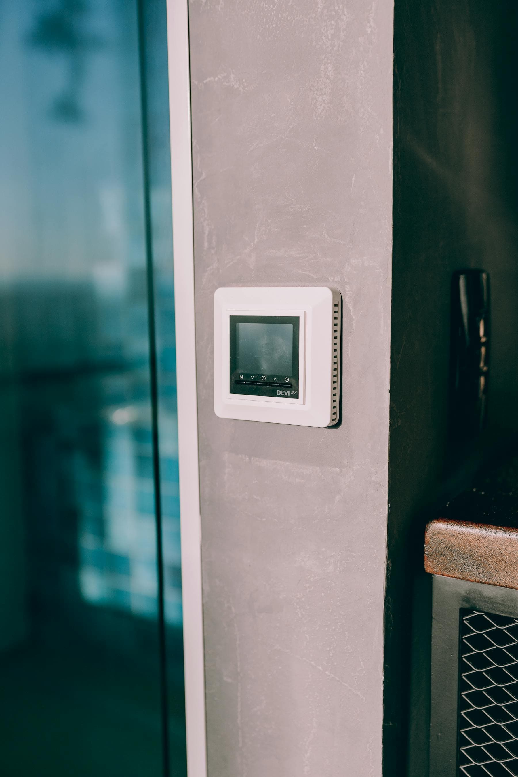 Digital thermostat mounted on an interior wall
